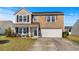 Traditional two-story home with brick and siding exterior, featuring a covered front porch at 182 Tibton Circle, Myrtle Beach, SC 29588