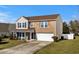 Charming two-story home featuring a brick facade, vinyl siding, and a two-car garage at 182 Tibton Circle, Myrtle Beach, SC 29588