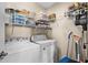 A functional laundry room with shelving above the washer and dryer for convenient storage at 182 Tibton Circle, Myrtle Beach, SC 29588