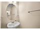 Small powder room with a pedestal sink, oval mirror and neutral wall paint at 182 Tibton Circle, Myrtle Beach, SC 29588