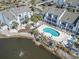 Aerial view showcases pool and pond surrounded by townhomes at 1891 Colony Dr. # 15-G, Surfside Beach, SC 29575