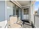 Balcony features a chair with a laundry closet visible through sliding glass door at 1891 Colony Dr. # 15-G, Surfside Beach, SC 29575