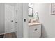 Clean bathroom with a white vanity, neutral walls, and decorative mirror at 1891 Colony Dr. # 15-G, Surfside Beach, SC 29575