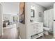 Hallway view into a modern bathroom featuring a shower and a marble vanity at 1891 Colony Dr. # 15-G, Surfside Beach, SC 29575