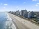 An aerial view of a long sandy beach is lined with hotels and condos at 2001 S Ocean Blvd. # 209, Myrtle Beach, SC 29577