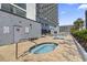 Hot tubs and pool area in a condo community, featuring brick-paved decking at 2001 S Ocean Blvd. # 209, Myrtle Beach, SC 29577