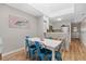 Coastal dining area with white table, blue chairs, and beach-themed decor, connecting to the kitchen at 207 3Rd Ave. N # 348, North Myrtle Beach, SC 29582