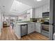 Bright kitchen featuring stainless steel appliances, green backsplash and view into the living room at 207 3Rd Ave. N # 348, North Myrtle Beach, SC 29582