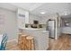 Bright kitchen featuring a breakfast bar with stools, stainless steel appliances, and green backsplash at 207 3Rd Ave. N # 348, North Myrtle Beach, SC 29582