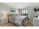 Cozy main bedroom with a floral-patterned bedspread, bedside tables, and a sunny window view at 207 3Rd Ave. N # 348, North Myrtle Beach, SC 29582