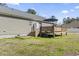 Backyard with wooden deck, stairs to yard, and mature trees at 2192 Bell Rd., Longs, SC 29568