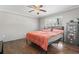 Cozy bedroom with a ceiling fan, hardwood floors, and a window bringing in natural light at 2192 Bell Rd., Longs, SC 29568