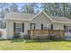 Charming single-story home with light siding, black shutters, and a wooden lattice front porch at 2192 Bell Rd., Longs, SC 29568