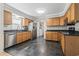 The kitchen features stainless steel appliances, dark countertops, tile flooring, and natural wood cabinets at 2192 Bell Rd., Longs, SC 29568