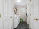 Laundry room with washer and dryer, storage shelf, and tiled floor at 2192 Bell Rd., Longs, SC 29568