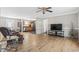 Bright living room with hardwood floors, flowing into kitchen and dining area, with ceiling fan at 2192 Bell Rd., Longs, SC 29568