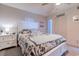 This is a stylish bedroom with white furniture and patterned bedding at 223 Maisons Dr. # A8, Myrtle Beach, SC 29572