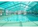 Inviting indoor pool area featuring clear, turquoise water, lounge chairs, and ample seating options at 223 Maisons Dr. # A8, Myrtle Beach, SC 29572