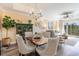 Elegant dining room with chandelier, stylish seating, and views into the inviting living room at 233 Banbury Ln. # 302, Little River, SC 29566