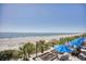 Expansive oceanfront beach view featuring palm trees, and umbrellas at 2401 S Ocean Blvd. # 359, Myrtle Beach, SC 29577