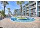 Beautiful lazy river with brick-paver surround and palm trees at resort in front of building with balconies at 2401 S Ocean Blvd. # 359, Myrtle Beach, SC 29577