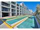 Shuffleboard court with palm trees and nearby building with balconies at 2401 S Ocean Blvd. # 359, Myrtle Beach, SC 29577