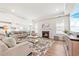 Spacious living room with a fireplace, large windows, and an open concept view of the kitchen at 2609 Turchino Ct., Myrtle Beach, SC 29579