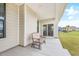 Covered patio with a comfortable bench, offering a relaxing outdoor space at 2609 Turchino Ct., Myrtle Beach, SC 29579