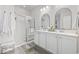 Bright bathroom showcasing a double vanity, framed mirrors, and a glass-enclosed shower at 2815 Eclipse Dr., Myrtle Beach, SC 29577