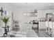 Cozy dining area with a modern chandelier, coffee bar, and adjacent kitchen featuring a central island at 2815 Eclipse Dr., Myrtle Beach, SC 29577