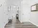 Hallway view showcasing luxury vinyl plank flooring with neutral walls and white doors at 2815 Eclipse Dr., Myrtle Beach, SC 29577