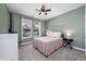 Bedroom featuring sage colored walls, carpet, ceiling fan and natural light from large window at 3105 White Jasmine Dr., Little River, SC 29566