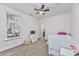 Bright bedroom features a ceiling fan, a window with blinds, carpeted floors, and soft, neutral walls at 3105 White Jasmine Dr., Little River, SC 29566