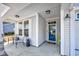 Charming front porch with seating area and decorative accents next to the home's light gray siding and modern fixtures at 3105 White Jasmine Dr., Little River, SC 29566