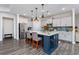 Modern kitchen featuring a large island, white countertops, stainless steel appliances, and hardwood floors at 3105 White Jasmine Dr., Little River, SC 29566