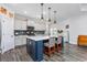 Modern kitchen with a large island, white countertops, stainless steel appliances, and hardwood floors at 3105 White Jasmine Dr., Little River, SC 29566