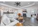 Bright living room features hardwood floors, a fireplace, and a view into the kitchen and other rooms at 3105 White Jasmine Dr., Little River, SC 29566