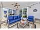 Screened in porch features blue furniture set, overhead fan and patio with outdoor dining area at 3105 White Jasmine Dr., Little River, SC 29566