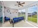 Covered porch with blue outdoor seating area, string lights and views of the backyard at 3105 White Jasmine Dr., Little River, SC 29566