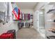 Spacious walk-in closet features built-in shelving, rods and opens to a beautifully tiled bathroom at 3105 White Jasmine Dr., Little River, SC 29566