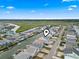 Aerial view of a waterfront neighborhood with houses and canals, lush green marshland in the background at 311 51St Ave. N, North Myrtle Beach, SC 29582