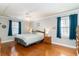 A traditional bedroom features two windows with drapes, hardwood floors, a ceiling fan, and a queen bed at 311 51St Ave. N, North Myrtle Beach, SC 29582