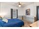 Comfortable bedroom featuring a ceiling fan, a window with gray curtains, and a blue bedspread at 311 51St Ave. N, North Myrtle Beach, SC 29582