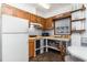 Traditional kitchen featuring wood cabinets, white appliances, and a cozy dining area with natural light at 311 51St Ave. N, North Myrtle Beach, SC 29582