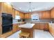 Well-equipped kitchen with wooden cabinetry, modern appliances, and a functional island at 311 51St Ave. N, North Myrtle Beach, SC 29582