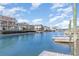 Scenic view of waterfront homes with private docks along a calm canal under a bright, partly cloudy sky at 311 51St Ave. N, North Myrtle Beach, SC 29582