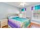 A bright bedroom with colorful decor and wood flooring offers a warm and inviting atmosphere at 354 Deer Run Ave., Georgetown, SC 29440