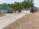 View of the garage, expansive driveway, and additional storage building at 354 Deer Run Ave., Georgetown, SC 29440