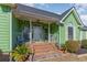 Inviting front porch with brick steps, white railings, a ceiling fan, and decorative plants at 354 Deer Run Ave., Georgetown, SC 29440