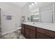 Well-lit bathroom with a vanity, large mirror, and a shower-tub combo with a patterned curtain at 357 Cabo Loop, Myrtle Beach, SC 29588